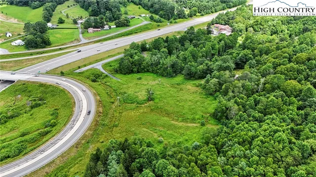 a view of a garden with a building in the background