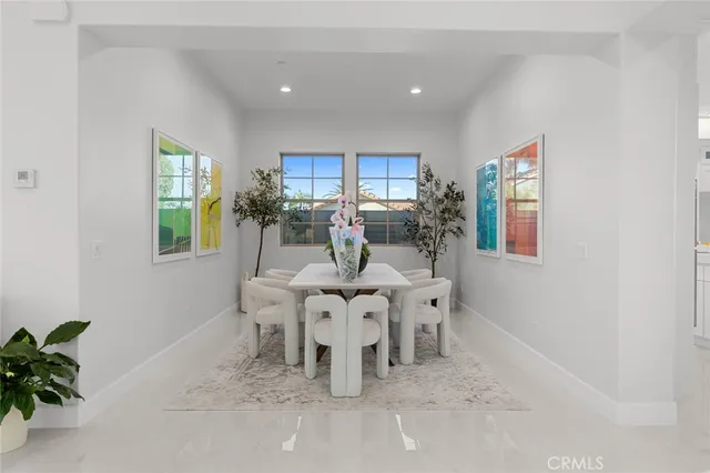 a kitchen with stainless steel appliances kitchen island granite countertop a refrigerator and a sink
