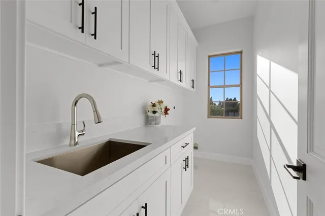 a bathroom with a double vanity sink toilet and shower
