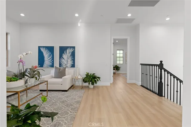 a bedroom with a large bed and a potted plant