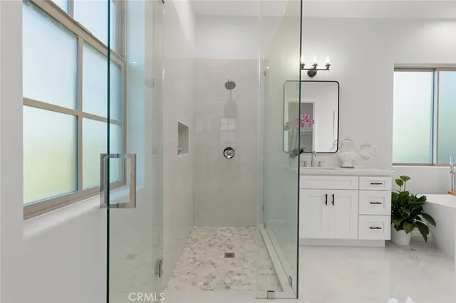 a view of a hallway with wooden floor and a living room