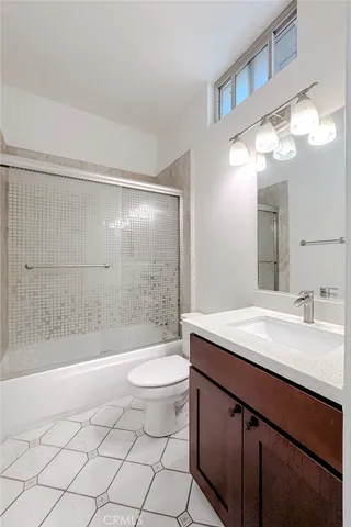 a bathroom with a sink a light fixture and a toilet