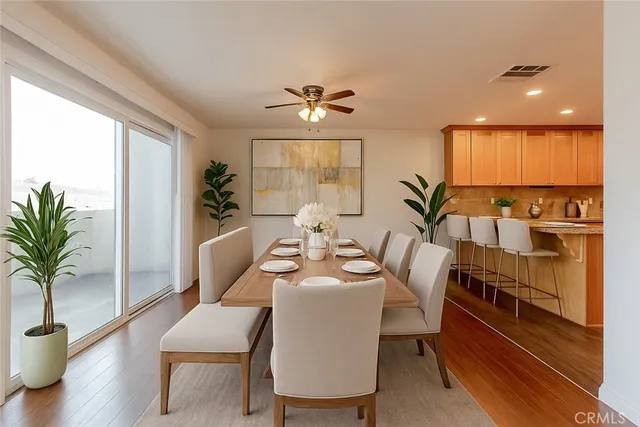 a view of a dining room with furniture window and wooden floor