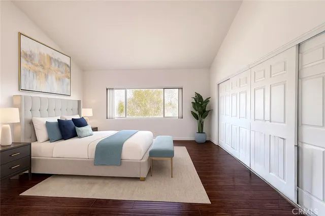 a bedroom with a large bed and a window