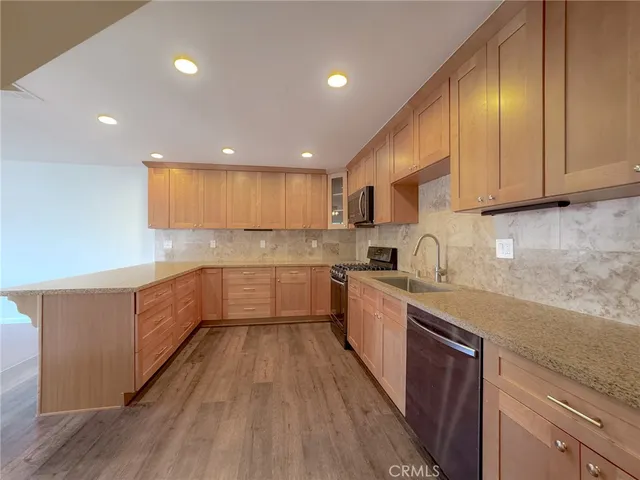a kitchen with sink cabinets and wooden floor
