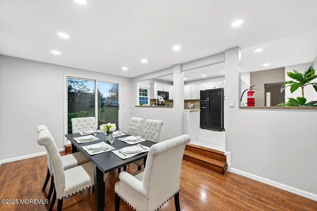 a dining room with furniture and wooden floor