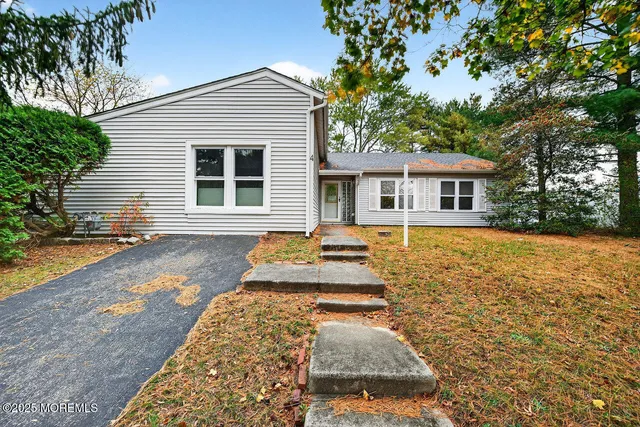 a front view of a house with yard patio and green space