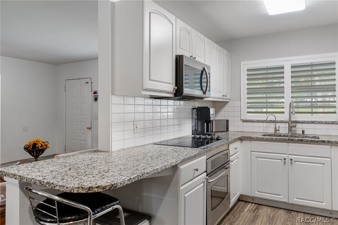 1140 South Highlands Avenue Inverness, FL 34452 - Photo 17 of 54 a kitchen with stainless steel appliances granite countertop a sink stove and cabinets