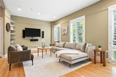 a living room with furniture and a clock