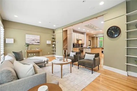 a dining room with furniture and potted plant