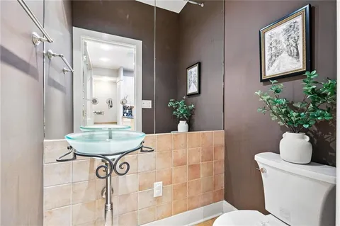 a bathroom with a glass shower door and a bathtub
