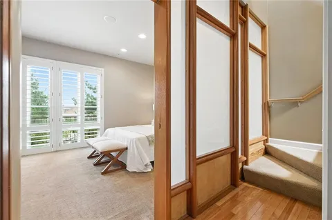 a spacious bedroom with a bed and a large window