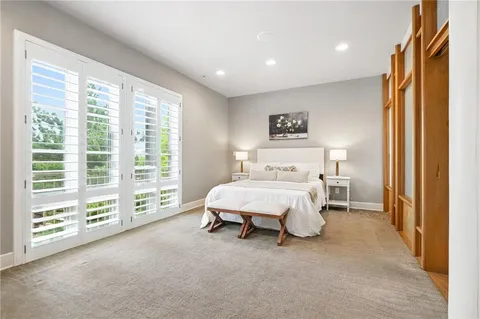 a spacious bedroom with a bed and a painting