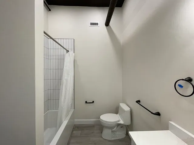 a bathroom with a toilet and a shower
