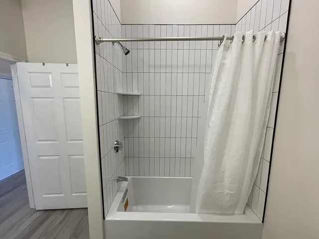 a bathroom with a shower and a sink