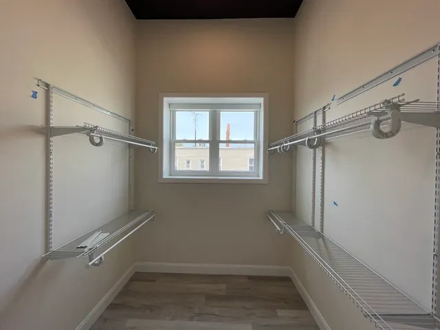 a bathroom with a window and a shower