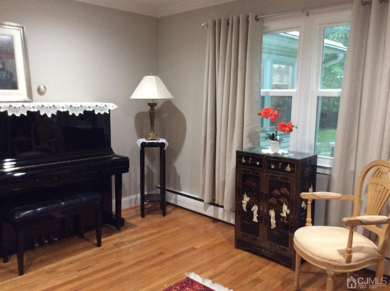 9 Devon Road Edison, NJ 08820 - Photo 11 of 58 a living room with furniture and a piano
