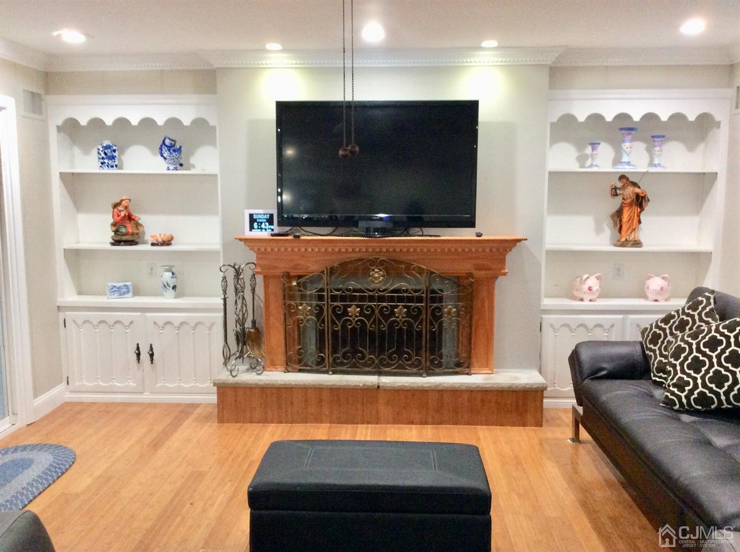 9 Devon Road Edison, NJ 08820 - Photo 13 of 58 a living room with fireplace furniture and a flat screen tv