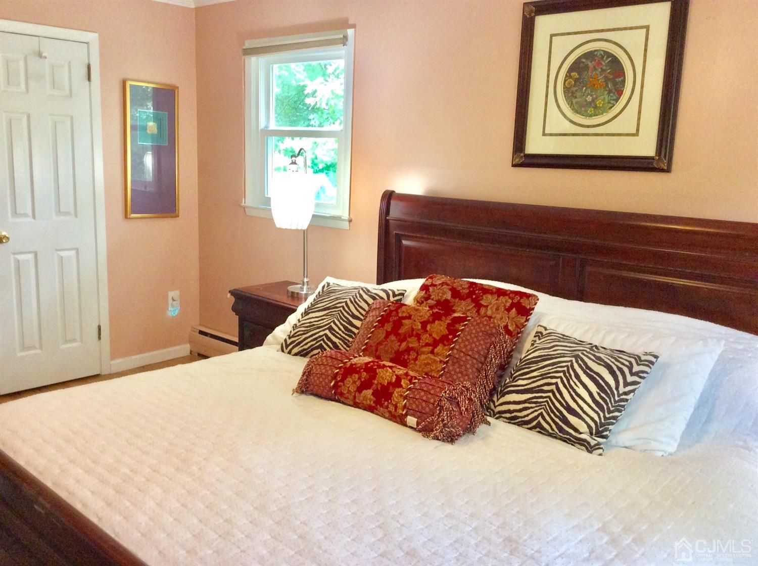 9 Devon Road Edison, NJ 08820 - Photo 22 of 58 a bedroom with a bed and painting on the wall