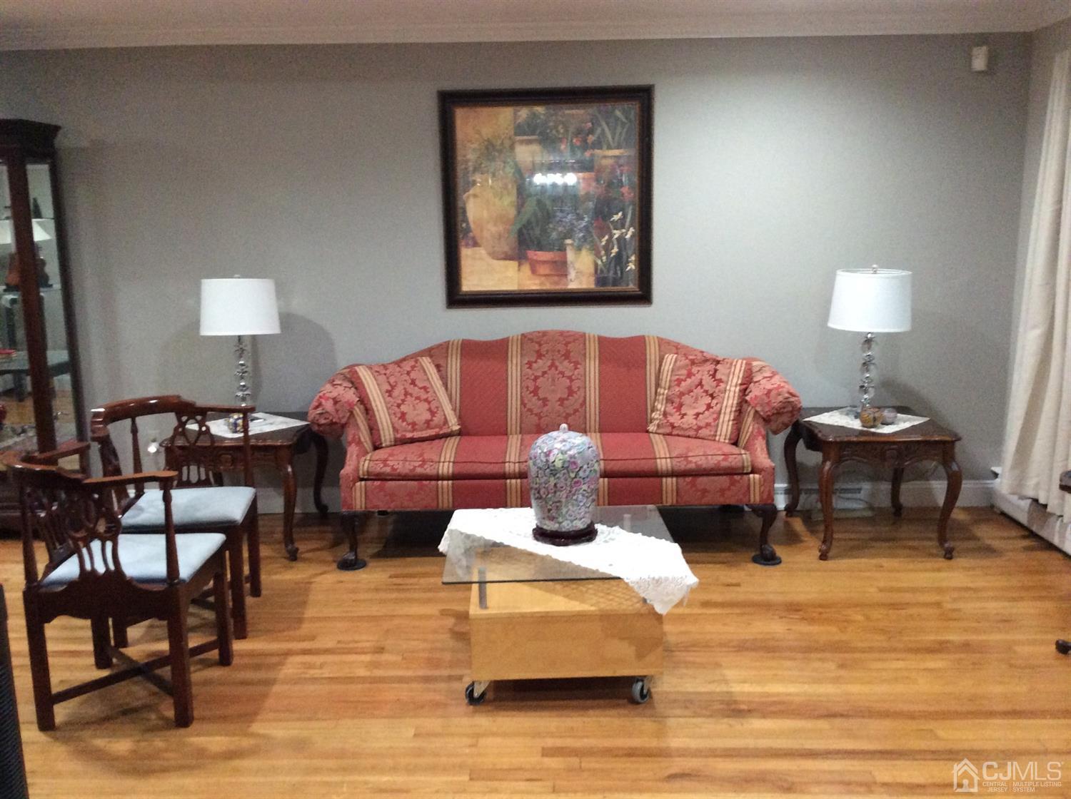9 Devon Road Edison, NJ 08820 - Photo 24 of 58 a living room with furniture and a lamp