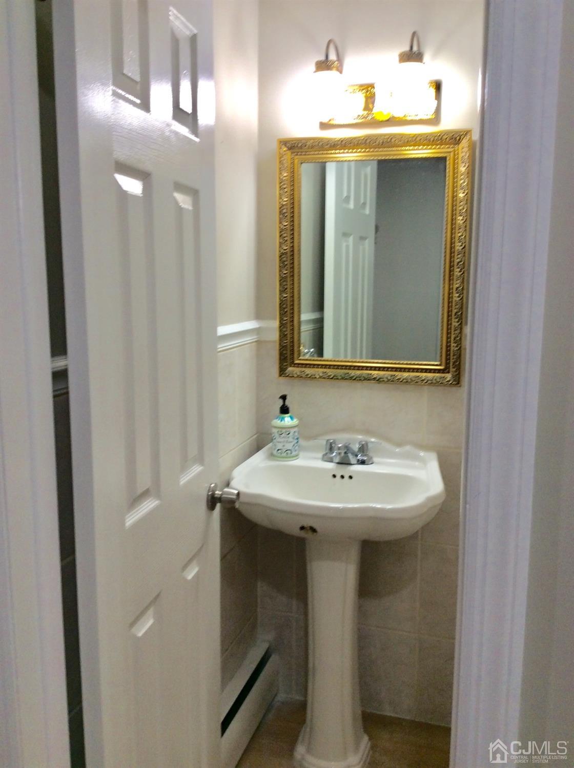 9 Devon Road Edison, NJ 08820 - Photo 25 of 58 a bathroom with a sink and a mirror