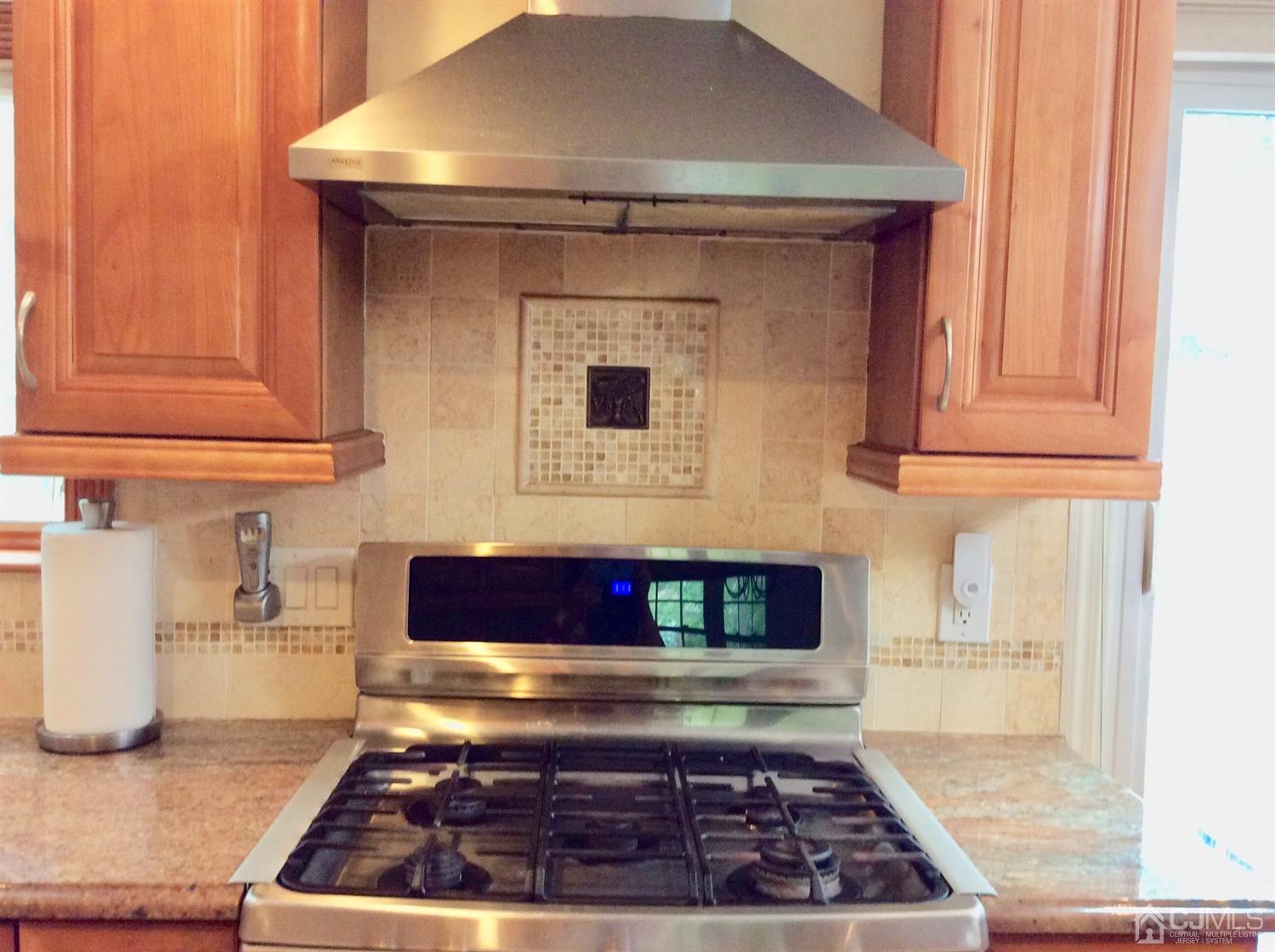 9 Devon Road Edison, NJ 08820 - Photo 29 of 58 a kitchen with wooden floor and a stove top oven
