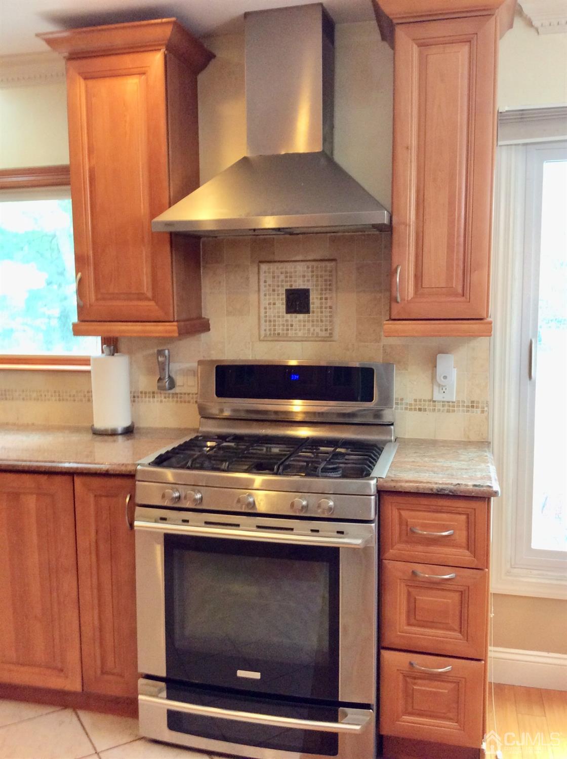 9 Devon Road Edison, NJ 08820 - Photo 30 of 58 a stove top oven sitting inside of a kitchen