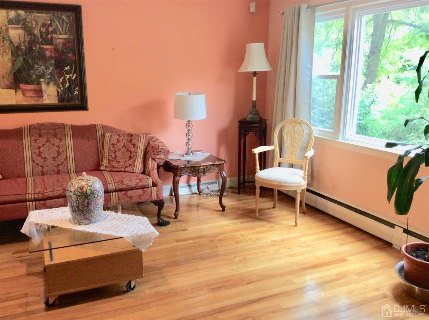 9 Devon Road Edison, NJ 08820 - Photo 33 of 58 a living room with furniture and a lamp