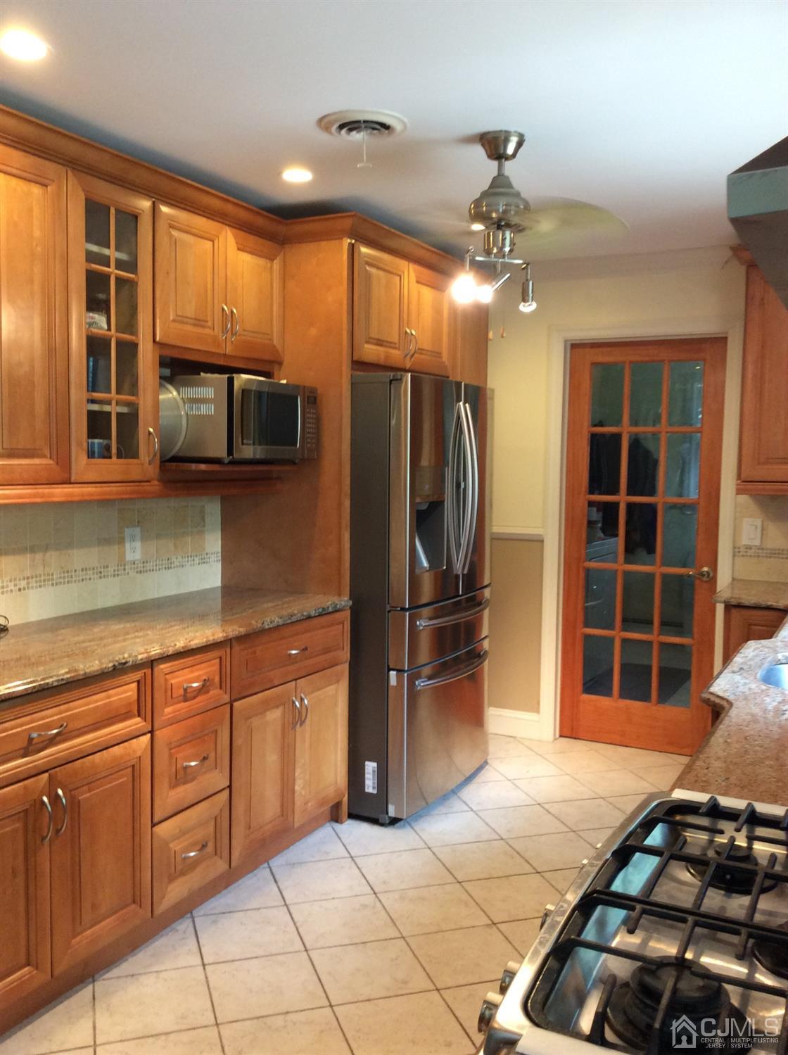 9 Devon Road Edison, NJ 08820 - Photo 39 of 58 a kitchen with stainless steel appliances granite countertop a refrigerator and a sink