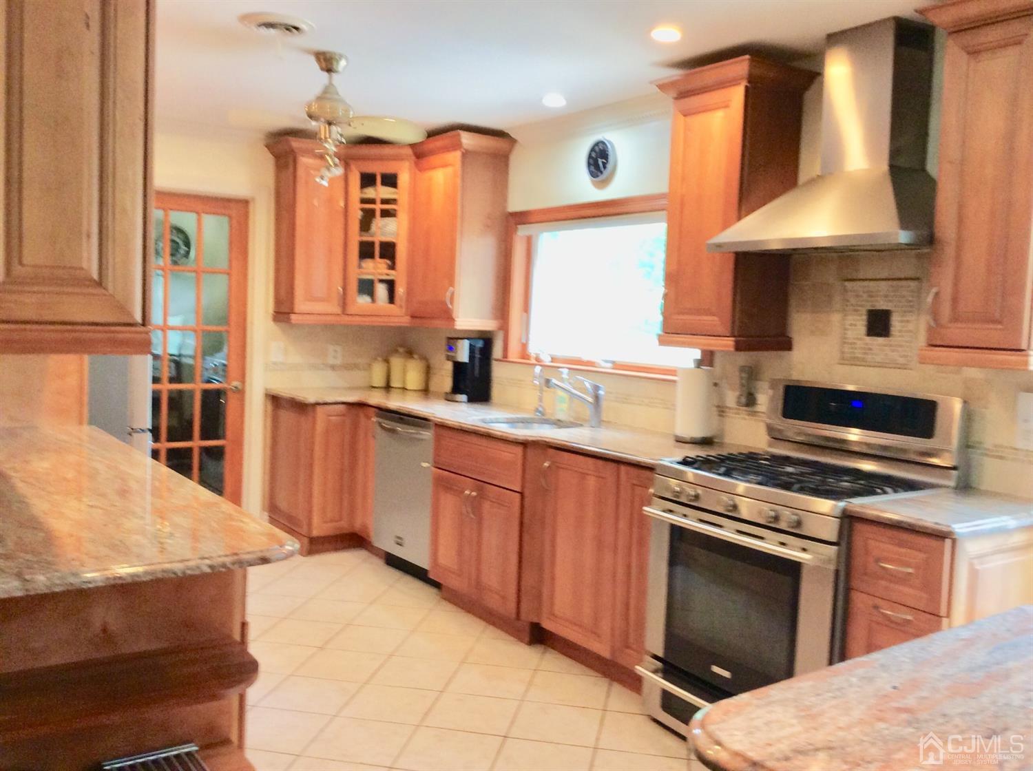 9 Devon Road Edison, NJ 08820 - Photo 43 of 58 a kitchen with stainless steel appliances a stove sink and cabinets