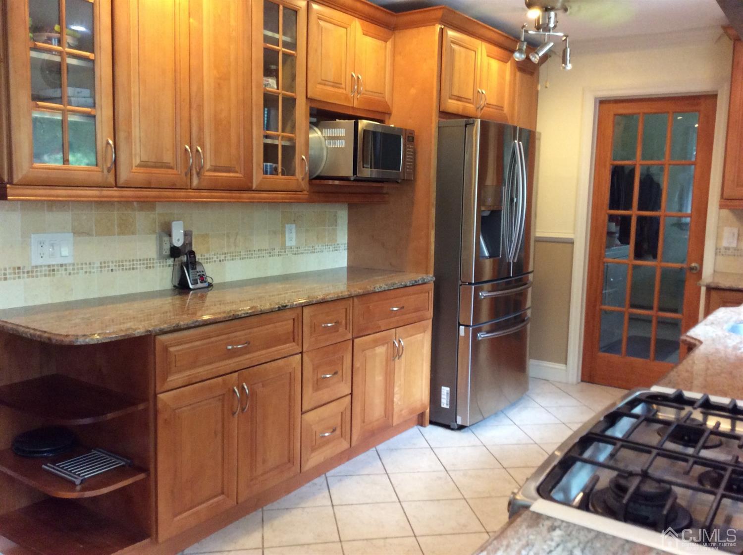 9 Devon Road Edison, NJ 08820 - Photo 44 of 58 a kitchen with stainless steel appliances granite countertop a refrigerator and a sink