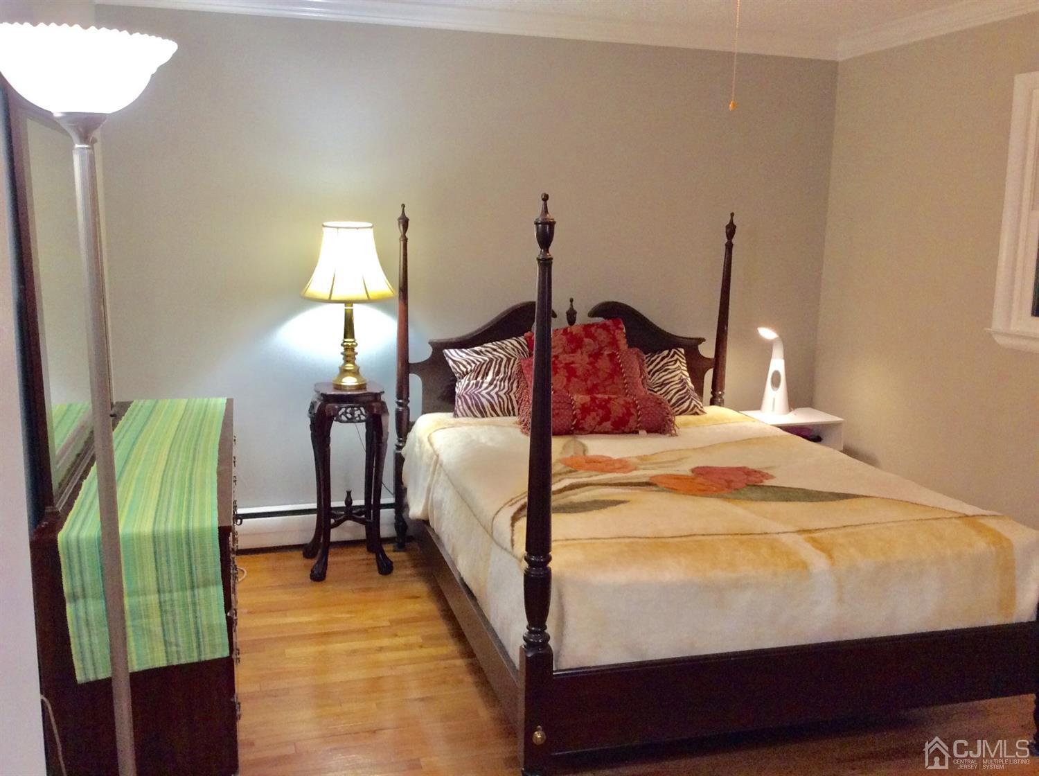 9 Devon Road Edison, NJ 08820 - Photo 50 of 58 a bed sitting in a bedroom with a lamp