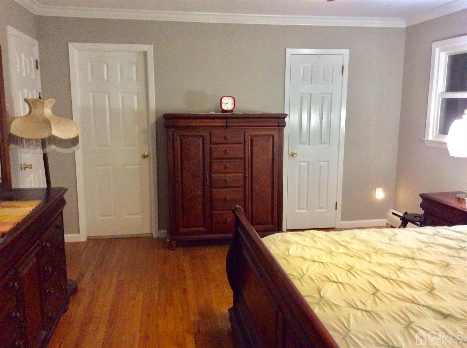 9 Devon Road Edison, NJ 08820 - Photo 52 of 58 a bed room with a bed and a chandelier