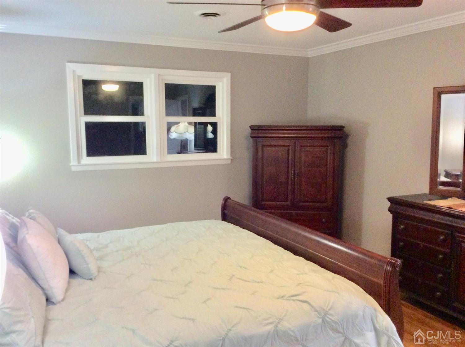 9 Devon Road Edison, NJ 08820 - Photo 56 of 58 a bedroom with a bed and a flat tv screen on dresser