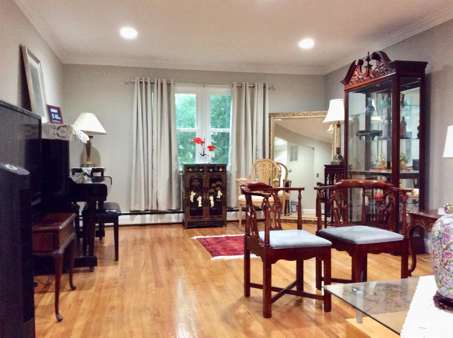 9 Devon Road Edison, NJ 08820 - Photo 10 of 58 a view of a livingroom with furniture and a flat screen tv