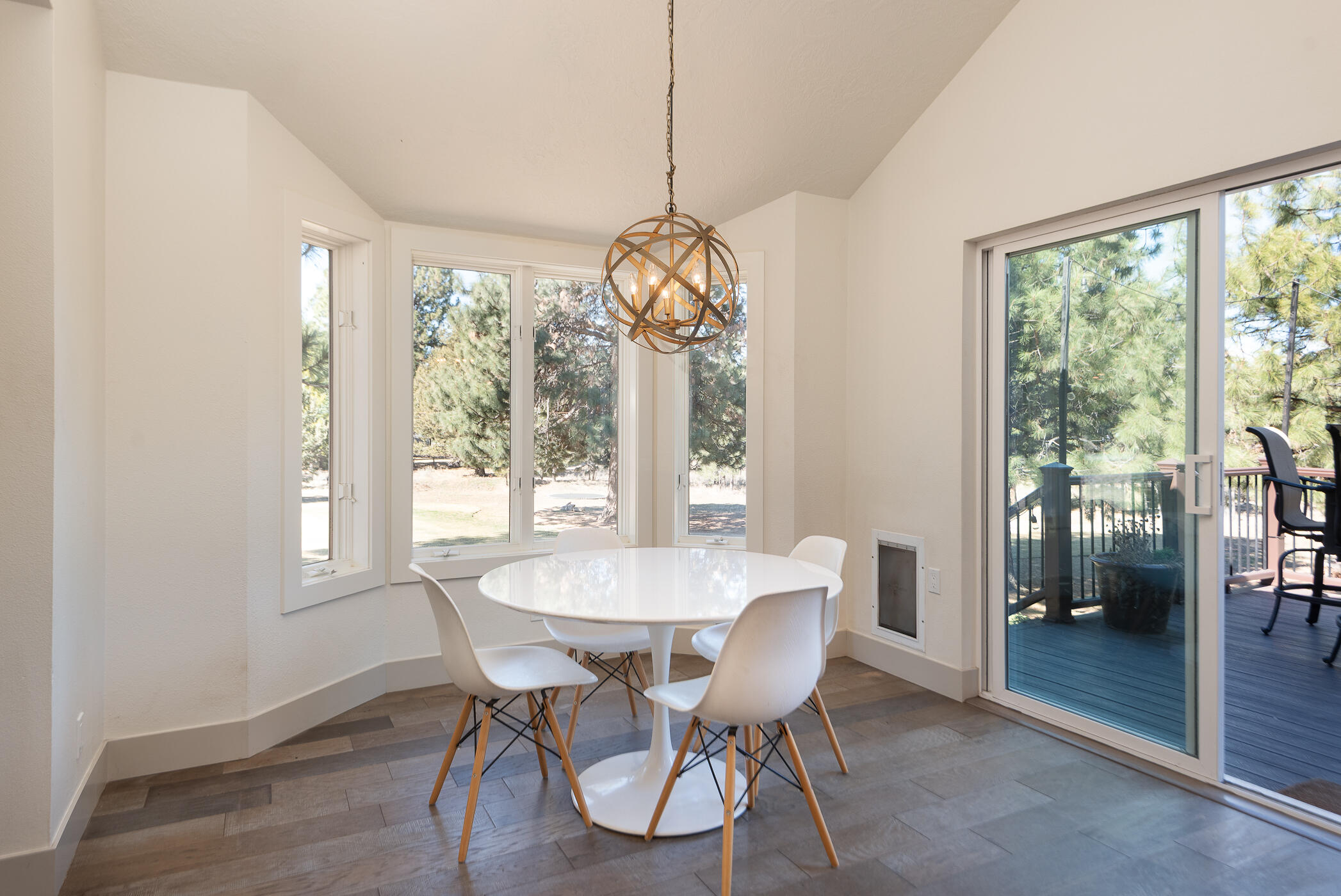 60012 West Ridgeview Drive Bend, OR 97702 - Photo 9 of 55 a dining room with furniture a chandelier and wooden floor