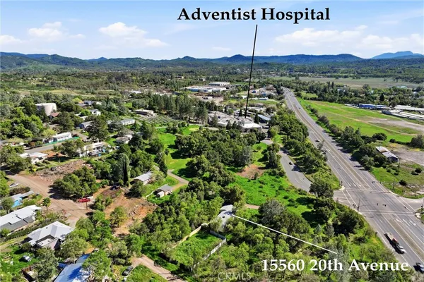 an aerial view of house with yard and green space
