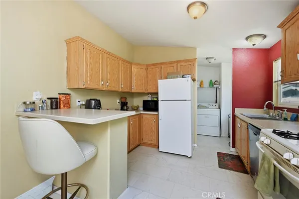 a kitchen with a refrigerator and a stove top oven