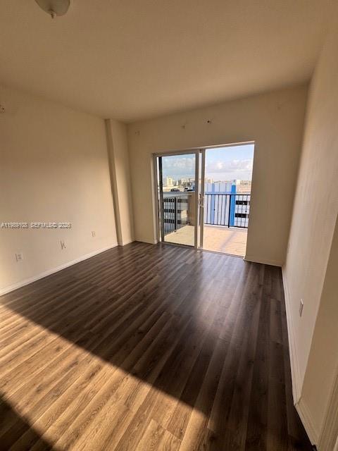 3410 Coral Way, Unit PH01 Miami, FL 33145 - Photo 2 of 10 a view of an empty room with wooden floor and a window