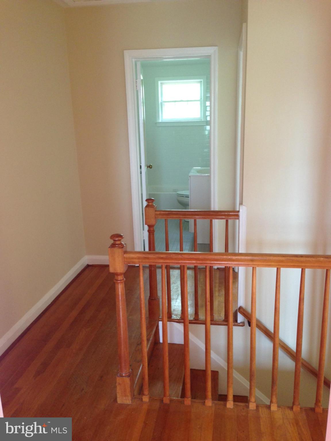 1220 Cedarcroft Road Baltimore, MD 21239 - Photo 12 of 22 a view of hallway with wooden floor