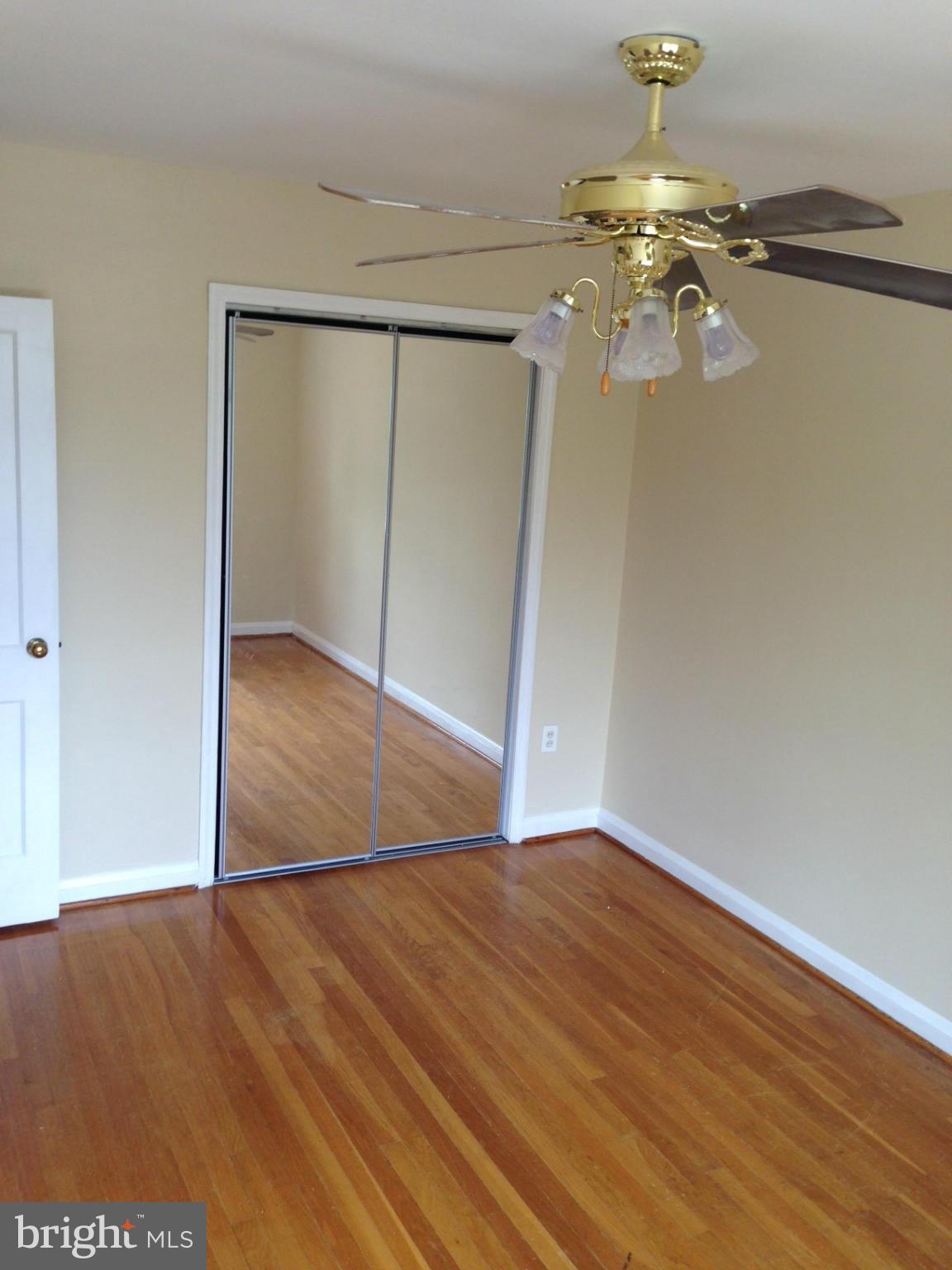 1220 Cedarcroft Road Baltimore, MD 21239 - Photo 15 of 22 a view of an empty room with wooden floor