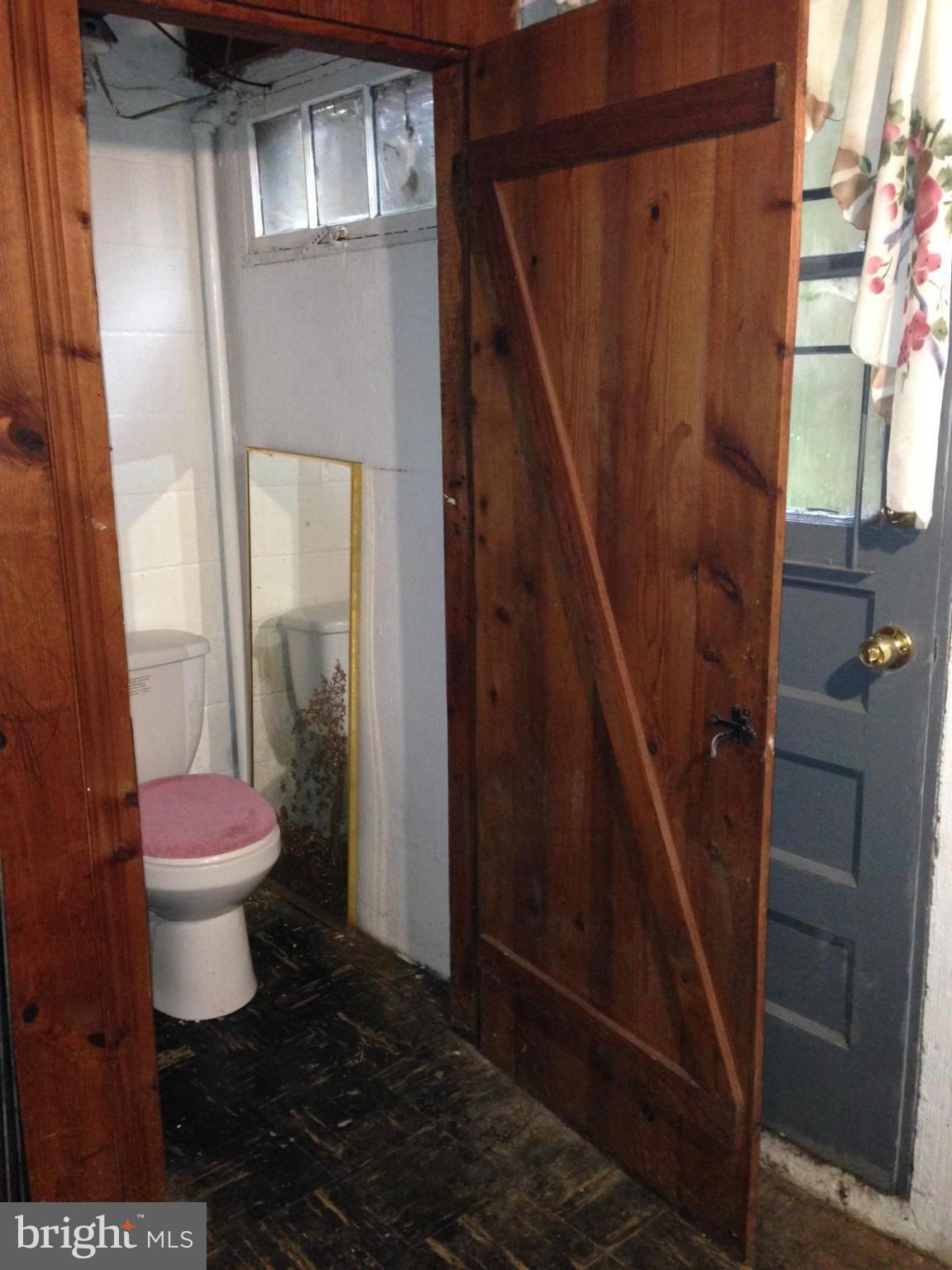 1220 Cedarcroft Road Baltimore, MD 21239 - Photo 20 of 22 a bathroom with a toilet and a shower