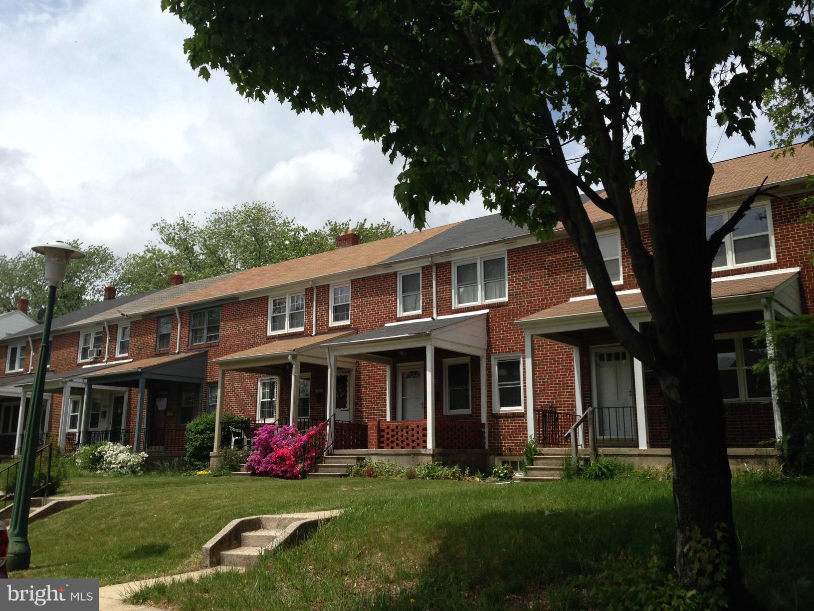 1220 Cedarcroft Road Baltimore, MD 21239 - Photo 22 of 22 front view of a brick house with a yard