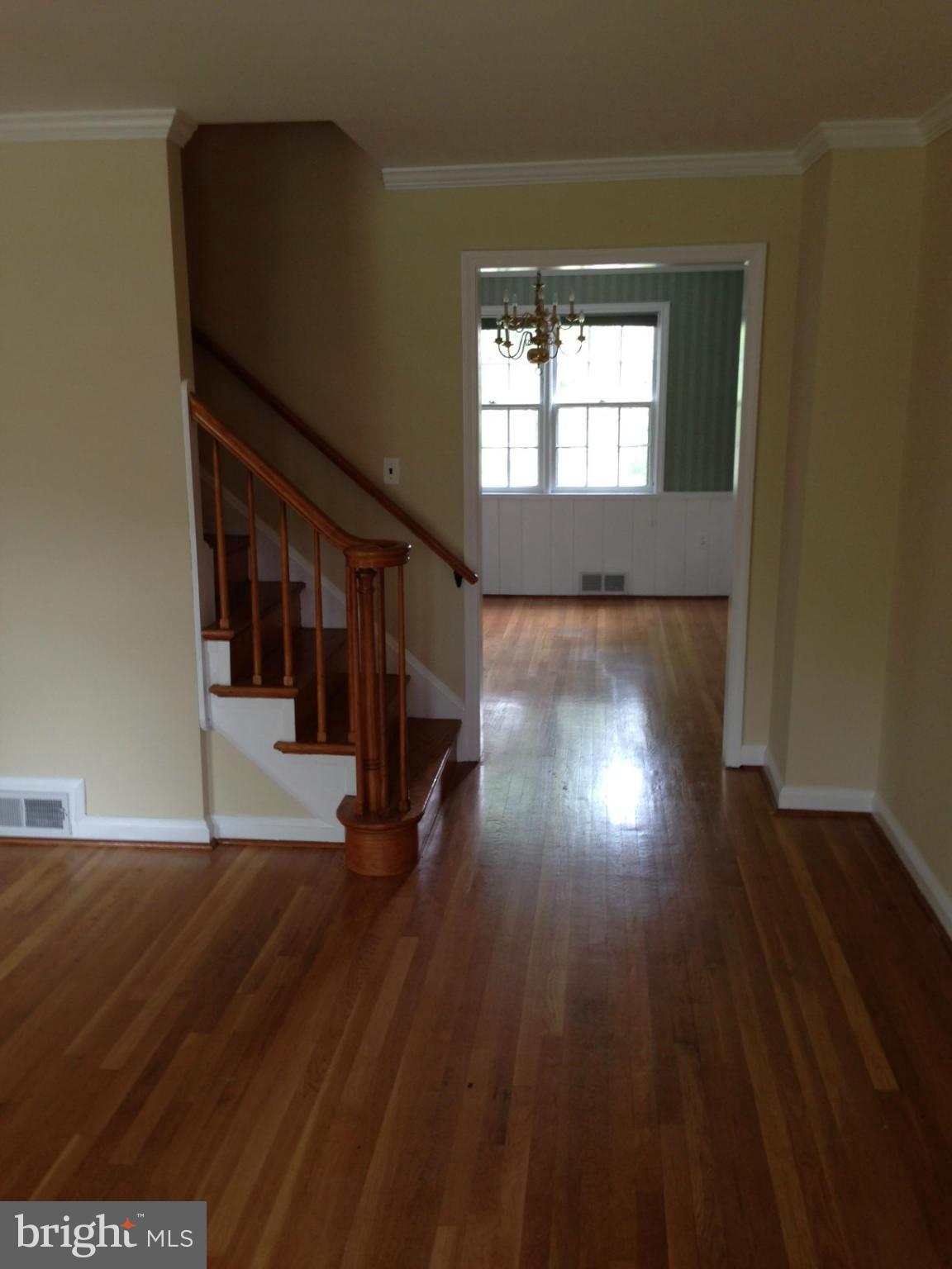 1220 Cedarcroft Road Baltimore, MD 21239 - Photo 5 of 22 a view of an empty room with wooden floor and a window