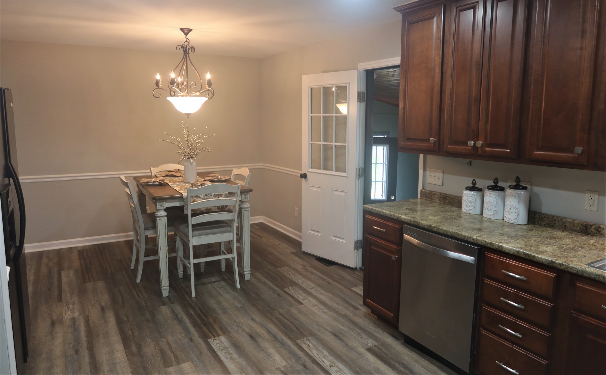 978 Riley Creek Road Tullahoma, TN 37388 - Photo 8 of 24 a kitchen with stainless steel appliances granite countertop wooden floors and chandelier