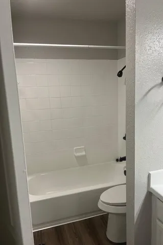 a bathroom with a shower a toilet and a shower