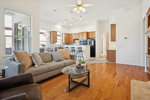 a living room with furniture and kitchen view