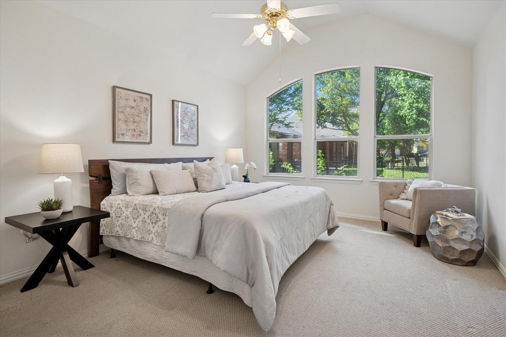 351 Rio Bravo Drive Fairview, TX 75069 - Photo 15 of 20 a spacious bedroom with a bed and a chandelier