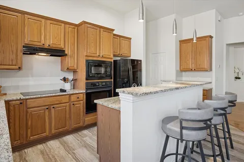 a kitchen with stainless steel appliances a stove refrigerator sink and cabinets