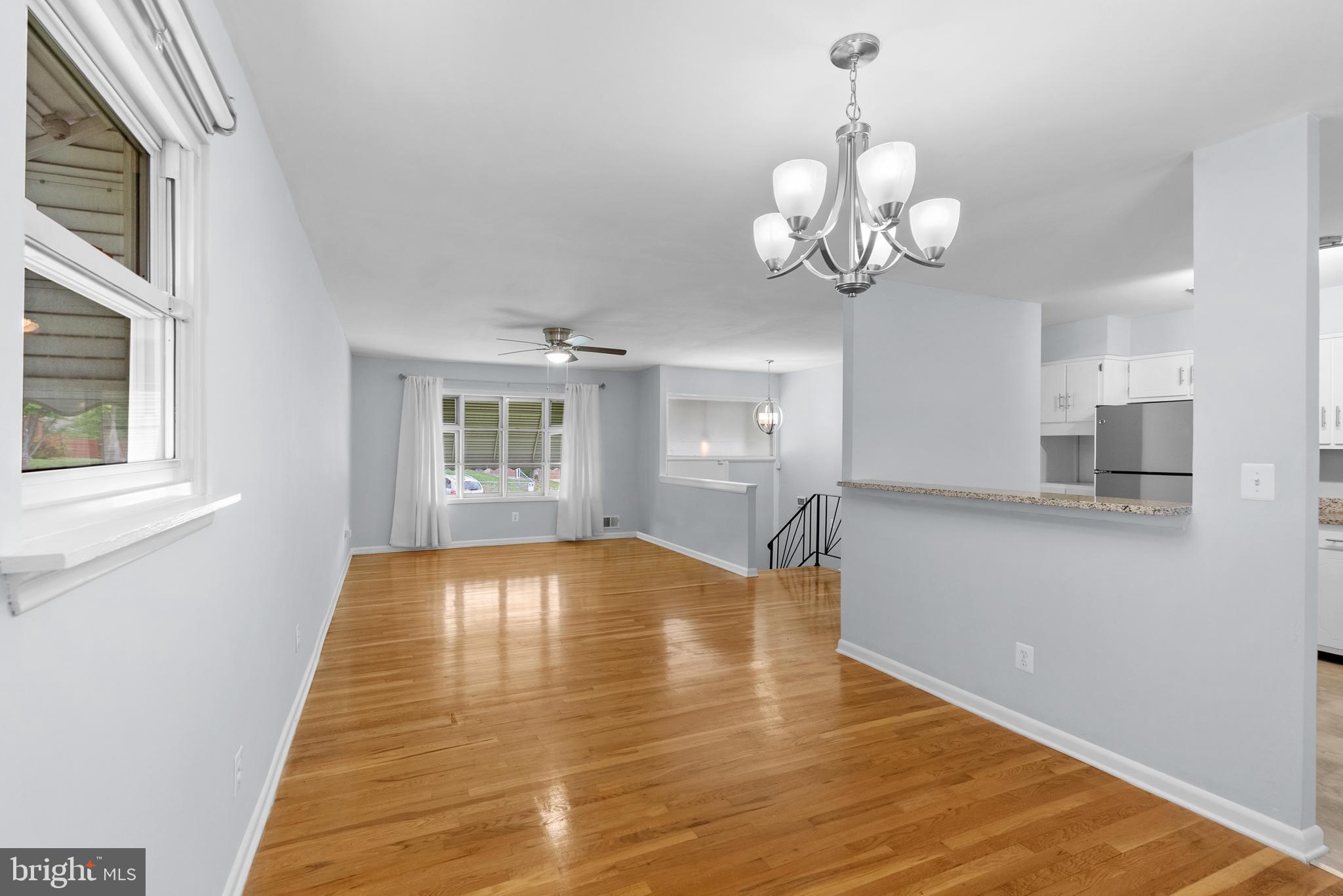 1201 Chillum Manor Road Hyattsville, MD 20783 - Photo 15 of 49 a view of an empty room with a window and wooden floor